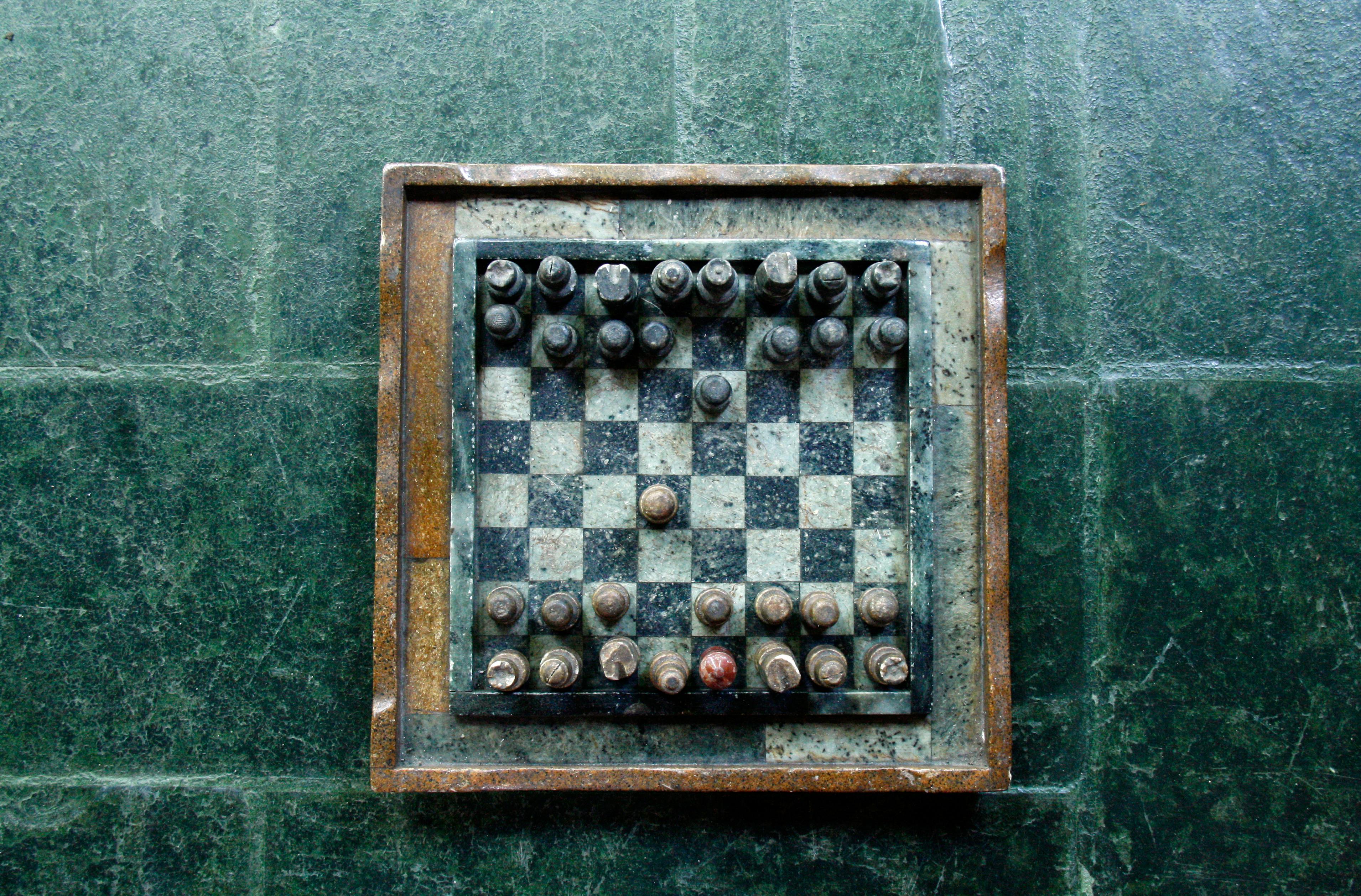 Chessboard on Green Surface. (Source: https://www.pexels.com/photo/chessboard-on-green-surface-57018/)