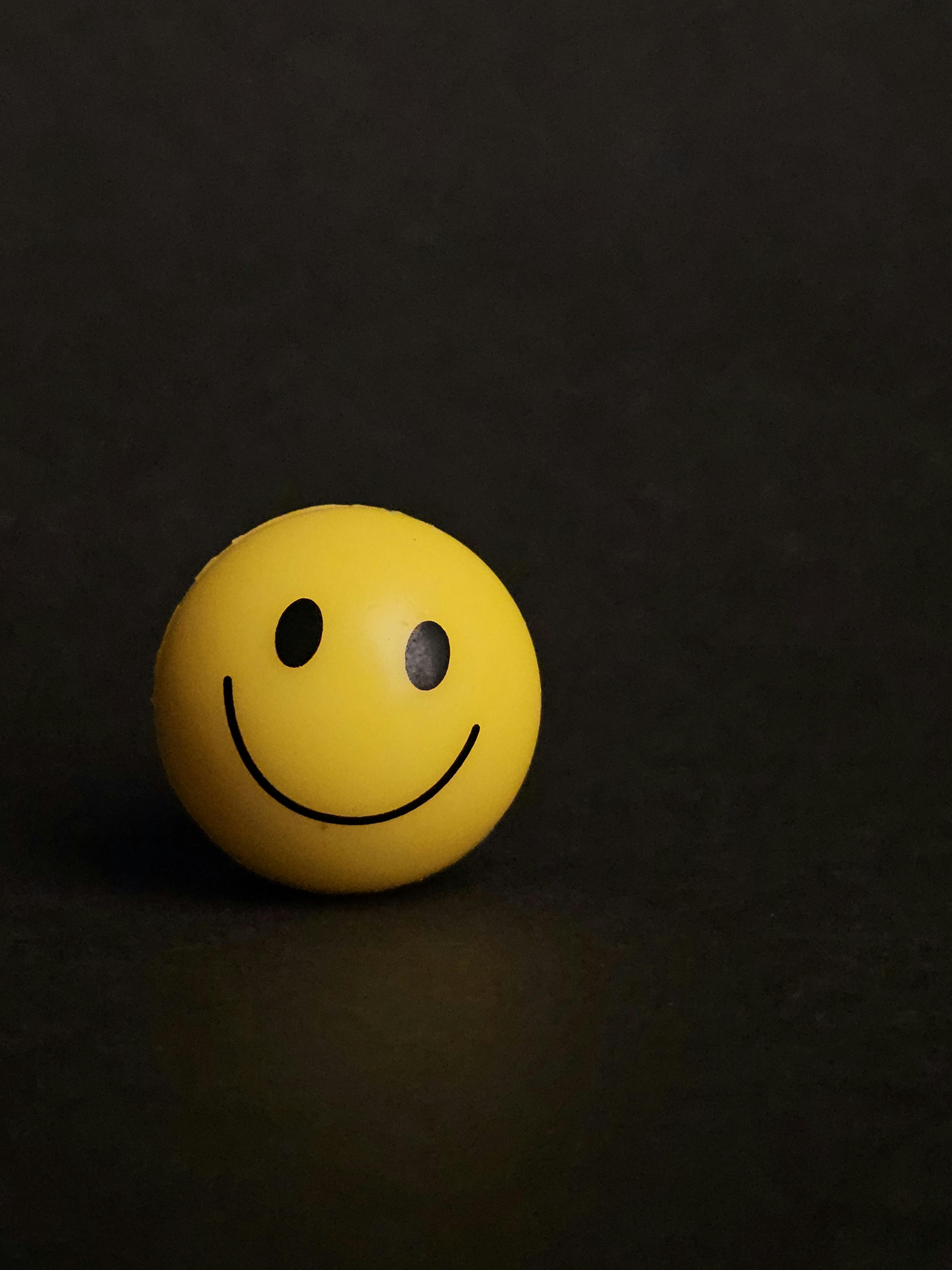 Smiley Face. (Source: https://www.pexels.com/photo/minimalist-smiley-face-ball-on-dark-background-34032758/)
